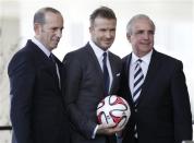 Don Garber (L), MLS commissioner, Miami-Dade County Mayor Carlos Gimenez (R) and David Beckham pose for a photo after a news conference in Miami, Florida February, 5, 2014. REUTERS/Andrew Innerarity