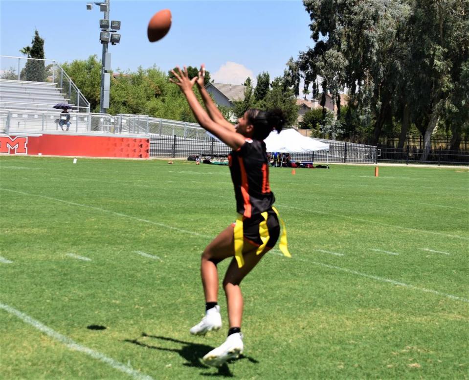 Merced High School freshman Averi Steverson hauls in a touchdown pass during a flag football game against Atwater on Saturday, Aug. 19, 2023 at Merced High School in Merced, Calif.