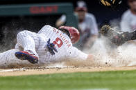 Philadelphia Phillies' Jean Segura (2) is out at home after Washington Nationals catcher Tres Barrera made a tag during the first inning of a baseball game, Monday, July 26, 2021, in Philadelphia. (AP Photo/Laurence Kesterson)