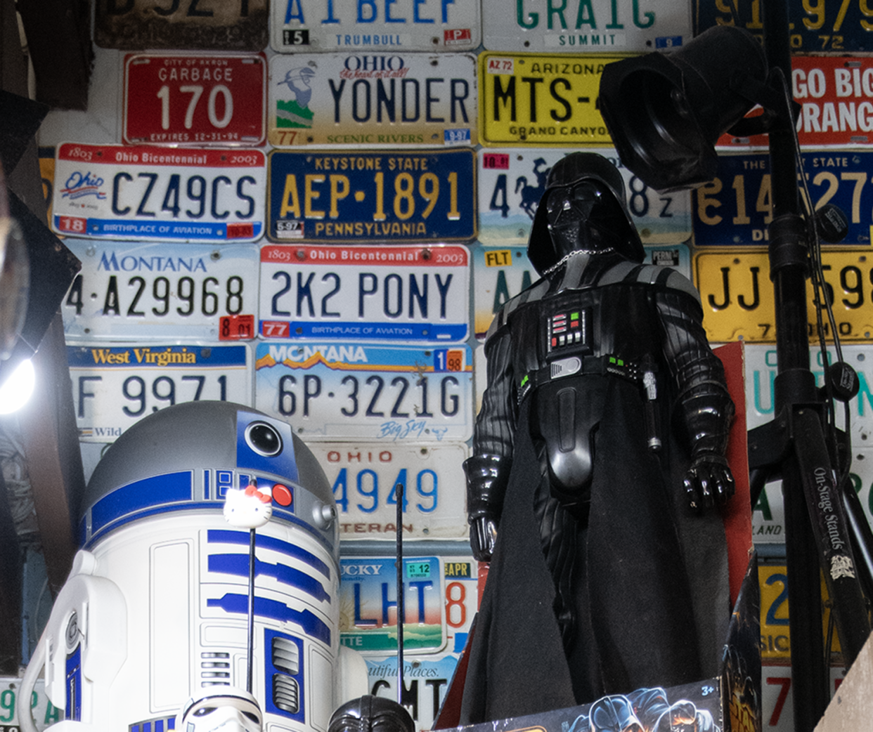 Star Wars items on display at Mike's Place in Kent include Darth Vader and R2-D2 figures on a ceiling shelf.
