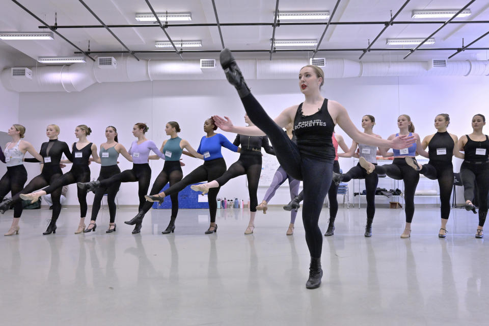 Amarisa LeBar, front, a Radio City Rockette, leads students in a Rockettes Precision Dance Technique course Wednesday, Feb. 8, 2023, at the Boston Conservatory at Berklee in Boston. LeBar, 25, of Iselin, N.J., started teaching at her mother's dance studio at 16, but finds sharing the Rockettes' style with college students definitely more intense. (AP Photo/Josh Reynolds)