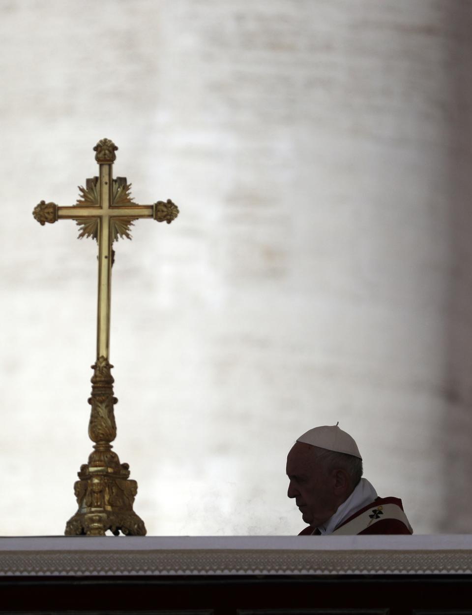 Pope Francis is silhouetted as he spreads incense on the altar during a Pentecost Mass in St. Peter's Square, at the Vatican, Sunday, June 9, 2019. The Pentecost Mass is celebrated on the seventh Sunday after Easter. (AP Photo/Gregorio Borgia)
