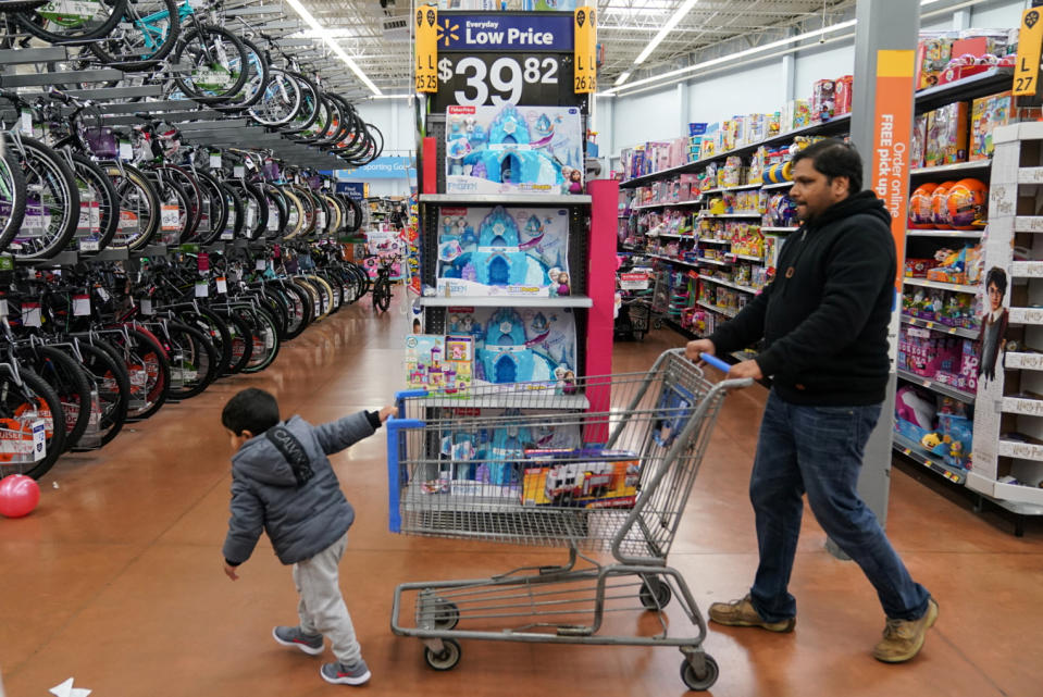 A boy and his father walk through the toy section of Walmart on Black Friday, a day that kicks off the holiday shopping season, in King of Prussia, Pennsylvania, U.S., on November 29, 2019. REUTERS/Sarah Silbiger.