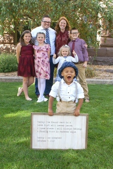 Myles Szerkins poses on his adoption day after being in the family since he was an infant.