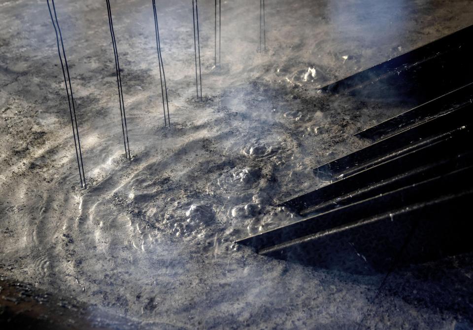 Metal pieces are galvanized in a galvanizing company in Meckenheim, Germany, Thursday, Aug. 18, 2022. In the six months since Russia invaded Ukraine, the fallout from the war has had huge effects on the global economy. Germany may have to impose gas rationing that could cripple industries from steelmaking to pharmaceuticals to commercial laundries. "If they say, we're cutting you off, all my equipment will be destroyed," said Kopf, who's also chair of Germany’s association of zinc galvanizing firms. (AP Photo/Michael Probst)