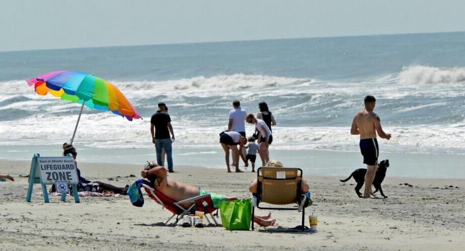 Swimmers head to the beach at Atlantic Beach after Hurricane Arthur on July 4, 2014.