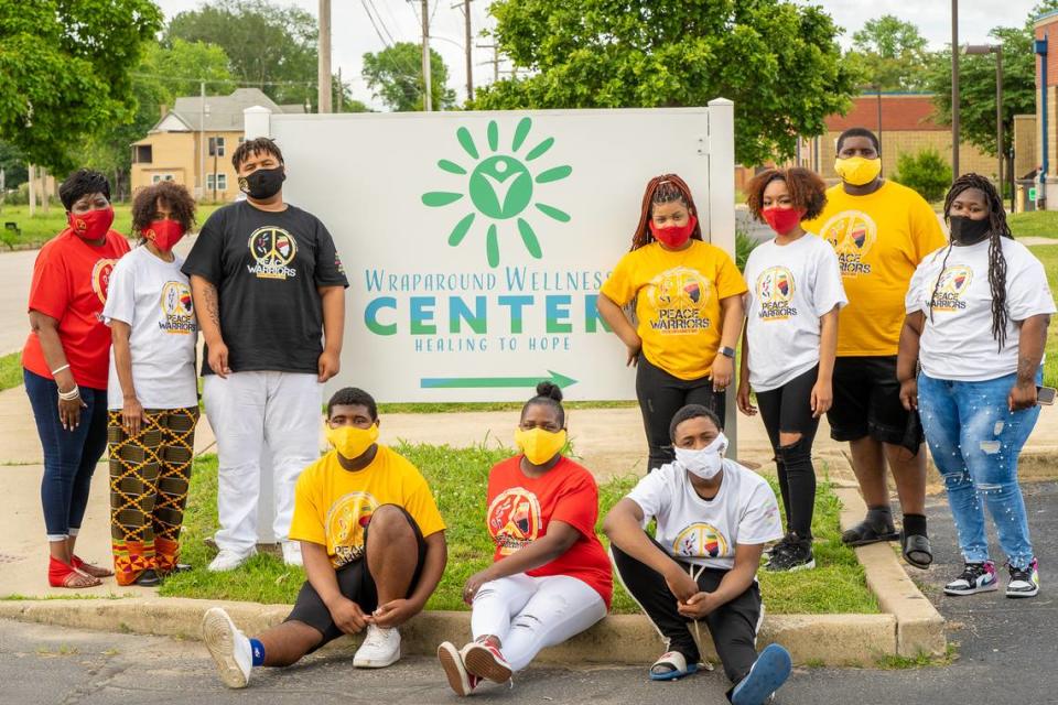 East St. Louis School District 189’s Peace Warriors, a youth group that addresses trauma by using Dr. Martin Luther King Jr’s nonviolent principles, stand in front of the Wraparound Wellness Center. The center formed last year.