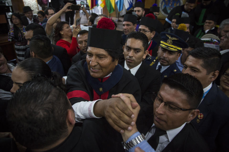 Bolivia's president Evo Morales is greeted by the crowd after he was awarded a Honorary Doctorate at the University of Guatemala, Thursday, Nov. 15, 2018. Morales is in Guatemala for the XXVI Iberoamerican Summit that is taking place in Antigua. (AP Photo/Oliver de Ros)