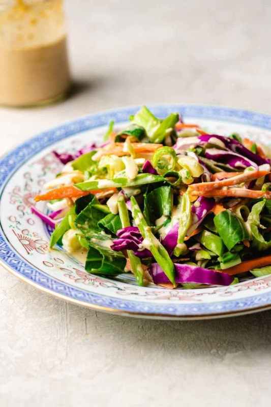 <p>I Heart Umami</p><p>This fresh and crunchy Paleo Asian Coleslaw has shredded vegetables and with a creamy toasted Japanese sesame dressing. </p><p><strong>Get the Recipe: </strong><a href="https://iheartumami.com/paleo-asian-coleslaw/" rel="nofollow noopener" target="_blank" data-ylk="slk:Paleo Asian Coleslaw;elm:context_link;itc:0;sec:content-canvas" class="link ">Paleo Asian Coleslaw</a></p>