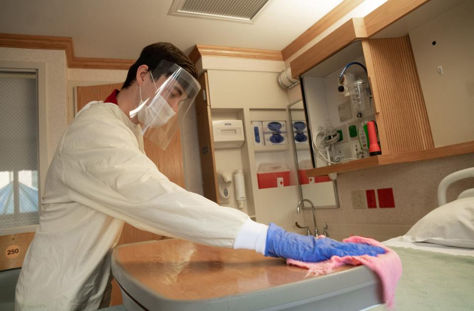 Jeffrey Kaethner, an environmental services tech, disinfects one of the rooms at UW Health University Hospital in Madison on May 6.