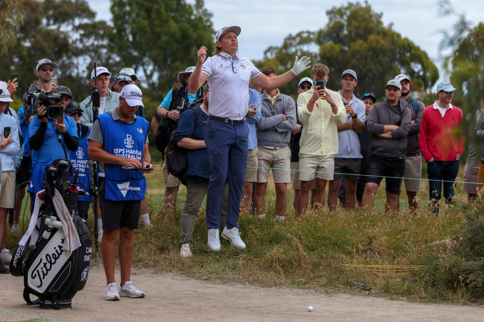 Australia's Cameron Smith leaps in the air to view the green after playing an errant shot on the 18th hole during the Australian Open golf championship at Victoria golf course in Melbourne, Australia, Thursday, Dec. 1, 2022. (AP Photo/Asanka Brendon Ratnayake)