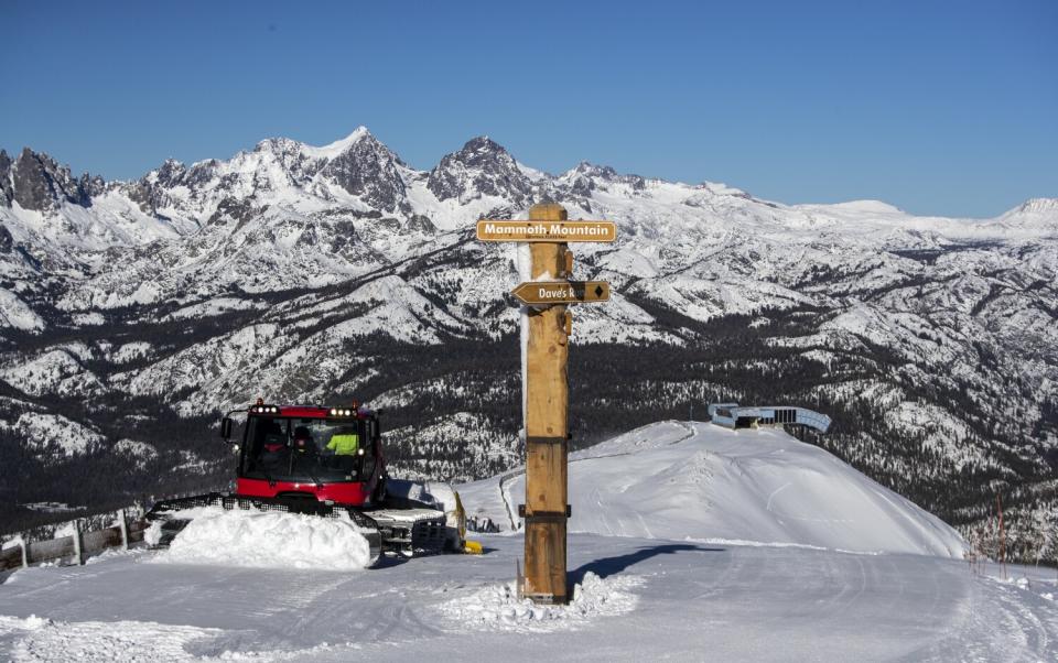 A snow plow sculpts a ridge atop the Mammoth Mountain summit
