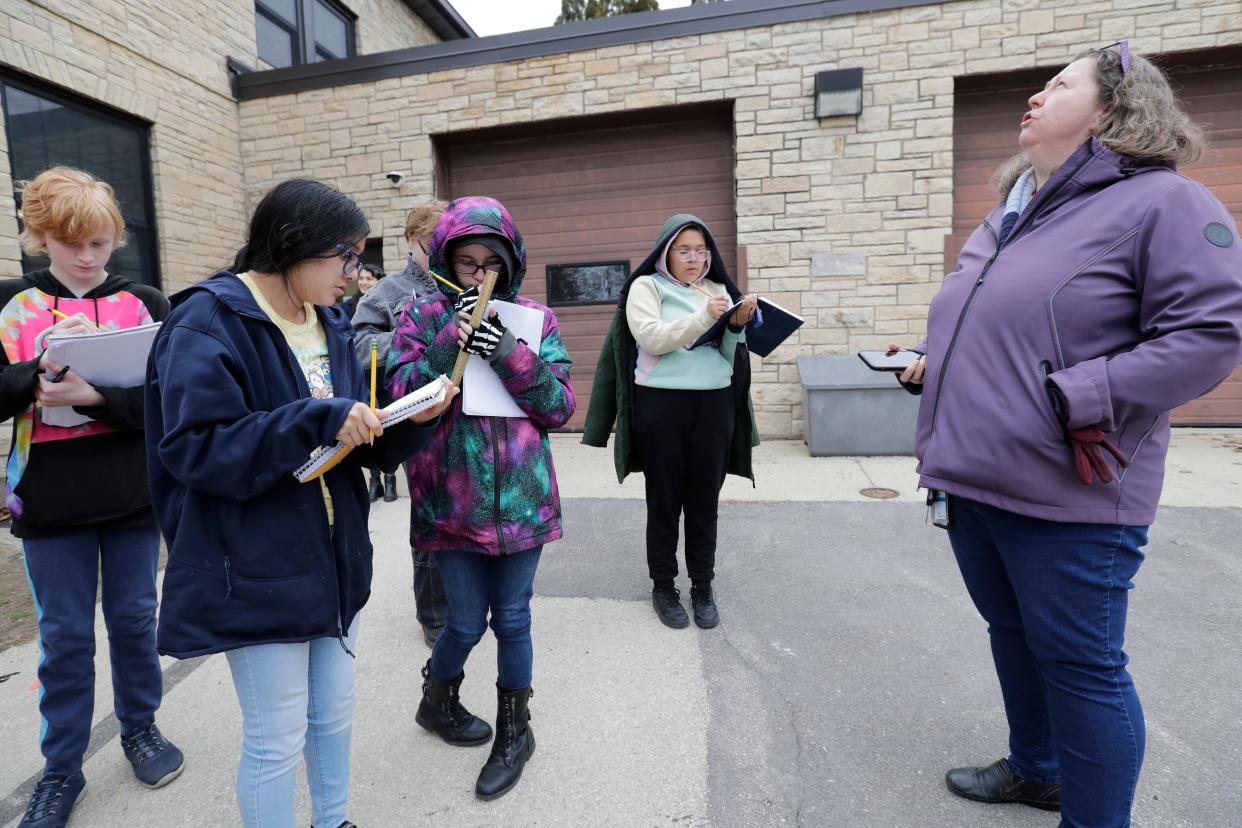 Teacher Joann Casper, right, keeps here eyes on potential rainfall as she leads students in an observation activity March 14 at Pierce Park in Appleton. During these activities, sixth-, seventh- and eighth-grade Fox River Academy students look for similarities and differences in things they see around them in nature.