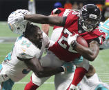 <p>Atlanta Falcons running back Tevin Coleman seperates Miami linebacker Lawrence Timmons from his helmet as he breaks the tackle to run for a touchdown taking a 17-0 lead during the second half in a NFL football game on Sunday, October 15, 2017, in Atlanta. Curtis Compton/ccompton@ajc.com </p>