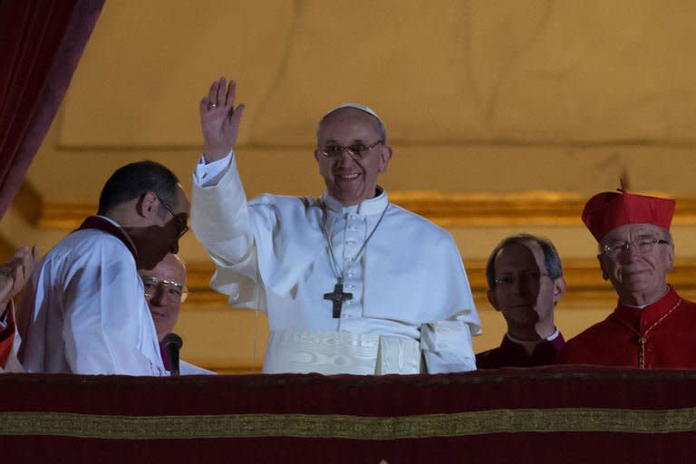 Argentina's Jorge Bergoglio, elected Pope Francis I waves from the window of St Peter's Basilica's balcony after being elected the 266th pope of the Roman Catholic Church on March 13, 2013 at the Vatican