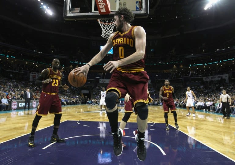 LeBron James (L) of the Cleveland Cavaliers scored 30 points against the Celtics, but it wasn't enough on a night the Cavaliers lost Kevin Love (C) to a bruised left thigh