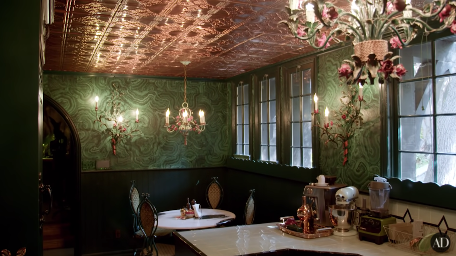 Another photo of Dita's green-themed kitchen with chandeliers