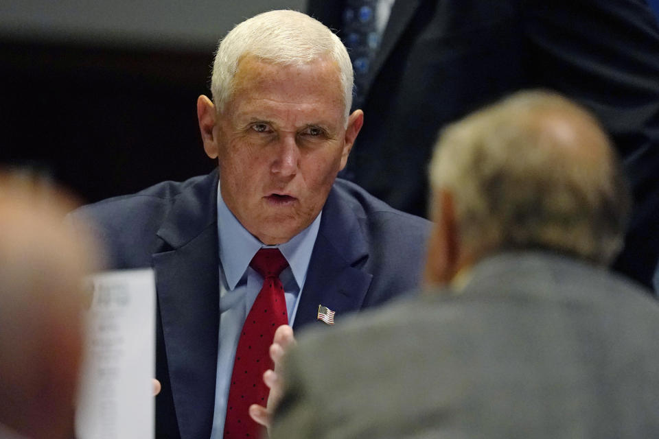 Former Vice President Mike Pence talks with a guest during the "Politics and Eggs" breakfast gathering, Wednesday, Aug. 17, 2022, in Manchester, N.H. (AP Photo/Charles Krupa)