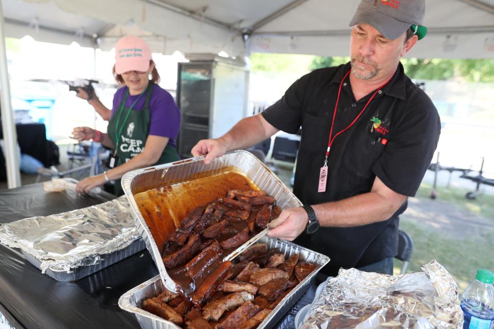 Mike Godwin from Paradise Grill piles the St. Louis-style ribs high for samplers at the Taste of BBQ Alley on May 16, 2019, during the annual Memphis in May World Championship Barbecue Cooking Contest at Tom Lee Park.