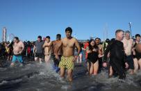 <p>Participants rush in the water during a polar bear plunge at the beach in Coney Island, Brooklyn on Jan. 1, 2018. New Yorkers took part in new year’s day swim with temperature standing at -7 degrees Celsius. (Photo: Atilgan Ozdil/Anadolu Agency/Getty Images) </p>