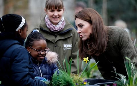  Catherine, Duchess of Cambridge talks to children as she visits the Islington community garden in north London on January 15, 2019. - Credit: AFP