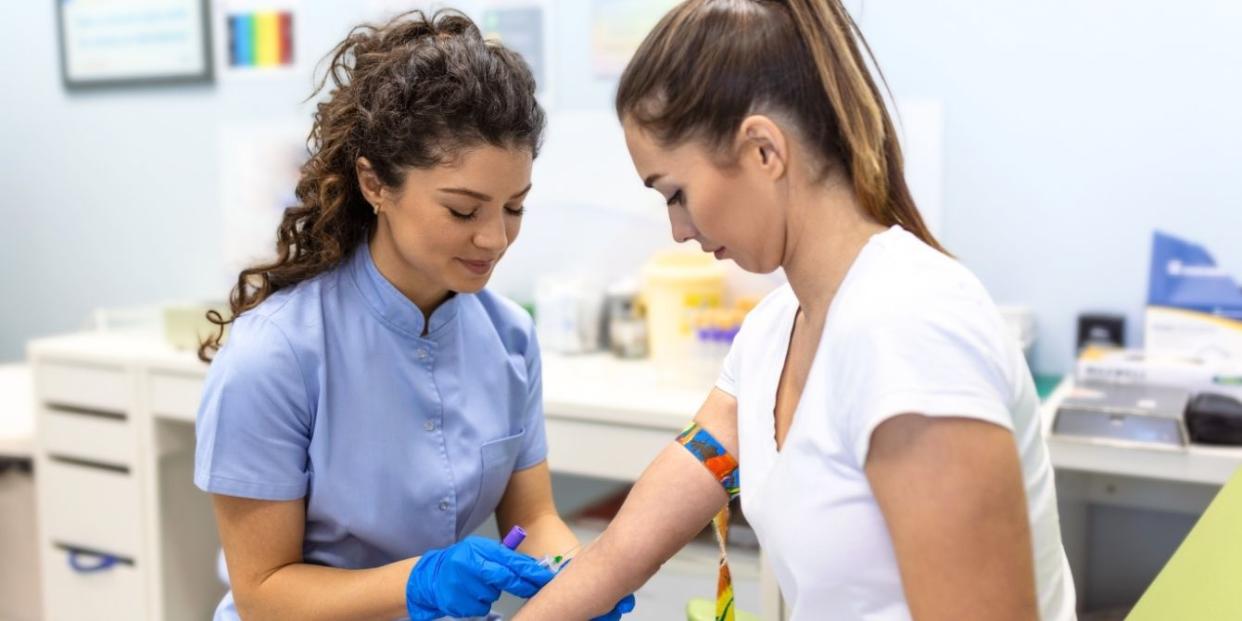 Woman getting blood drawn at doctor