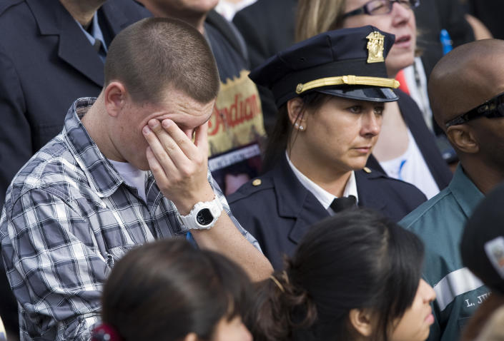 NEW YORK, NY - SEPTEMBER 11: People observe a moment of silence at the time the second hijacked airliner crashed into the south tower of the World Trade Center during the tenth anniversary ceremonies of the September 11, 2001 terrorist attacks at the World Trade Center site, September 11, 2011 in New York City. New York City and the nation are commemorating the tenth anniversary of the terrorist attacks which resulted in the deaths of nearly 3,000 people after two hijacked planes crashed into the World Trade Center, one into the Pentagon in Arlington, Virginia and one crash landed in Shanksville, Pennsylvania. (Photo by Kristoffer Tripplaar-Pool/Getty Images)