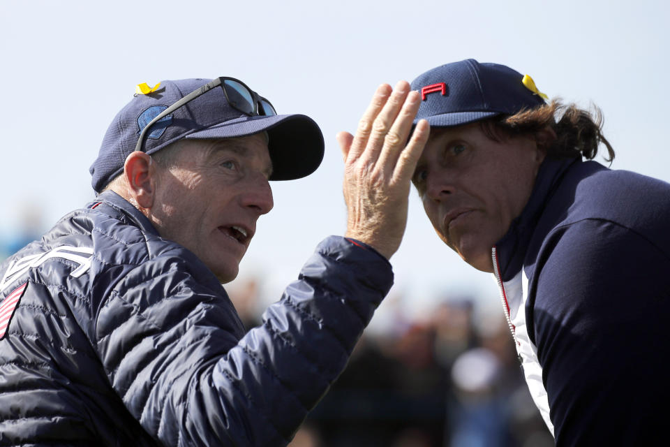 US team captain Jim Furyk gestures while speaking with his player Phil Mickelson during a fourball match on the second day of the 2018 Ryder Cup at Le Golf National in Saint Quentin-en-Yvelines, outside Paris, France, Saturday, Sept. 29, 2018. (AP Photo/Francois Mori)