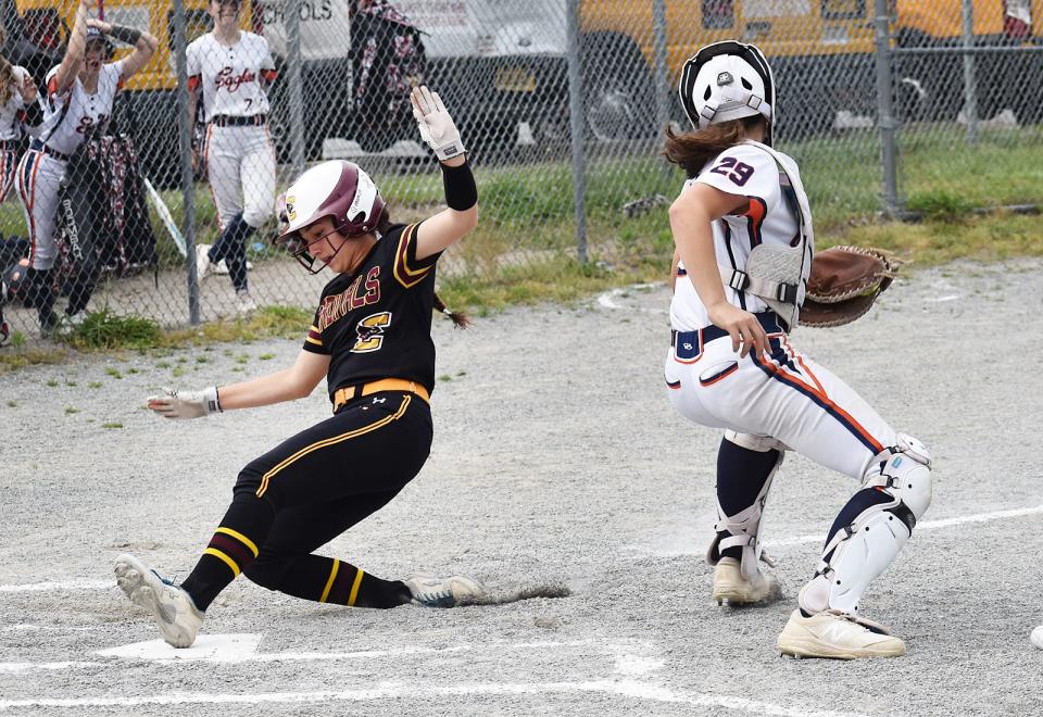 Case's Skye Dupre slides safe at home plate as Eagles catcher Sophia Hammel is late making the tag