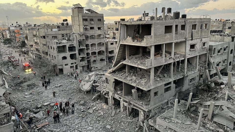 PHOTO: Palestinians walk at the site of Israeli strikes on houses, in Jabalia refugee camp in the northern Gaza Strip Nov, 21, 2023.  (Abed Sabah/Reuters)