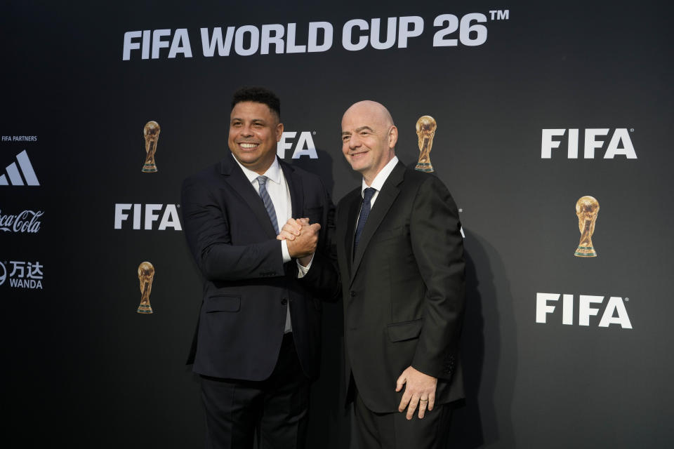 FIFA President Gianni Infantino, right, and Brazilian soccer great Ronaldo arrive for a ceremony unveiling the official brand of the 2026 World Cup, at Griffith Observatory in Los Angeles Wednesday, May 17, 2023. (AP Photo/Jae C. Hong)