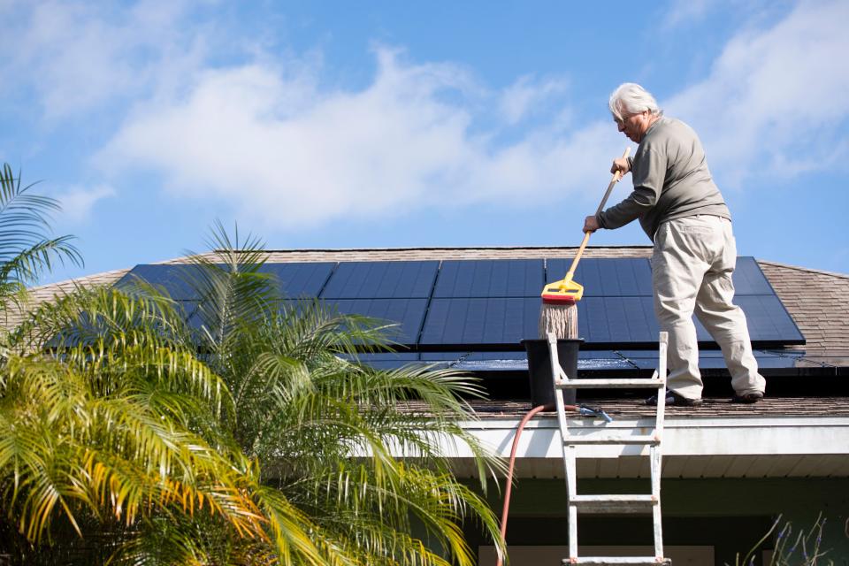 Jerry Buechler, of Port St. Lucie, cleans the 28 solar panels on his roof Wednesday, Dec. 4, 2019, in Port St. Lucie. Buechler has converted his 4-bedroom, 3-bathroom house to completely run off solar energy and also drives an electric vehicle and uses an electric lawn mower. He formed the Treasure Coast Solar Co-op with fellow retired Miami Beach firefighter Richard Silvestri after seeing streets in Miami Beach flooding on sunny days and watching the city spend over $500 million raising streets and putting in pumps. "It's a short-term solution to a long-term problem. The only real solution... is to reduce our carbon footprint," Buechler said. 