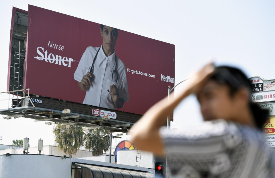 This May 9, 2018 photo shows a billboard for MedMen, a marijuana dispensary, at an intersection in Los Angeles. MedMen recently rolled out an ad campaign that featured photos of 17 people including a white-haired grandmother, a schoolteacher, a business executive, a former pro football player and a nurse, being splashed across billboards, buses and the web. (AP Photo/Chris Pizzello)