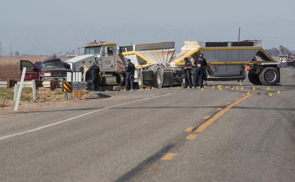 Investigators work the scene of a two vehicle crash that killed at least 13 people on Highway 115 near Holtville, Ca., March 2, 2021.