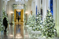 The Cross Hall of the White House is decorated for the holiday season during a press preview of the White House holiday decorations, Monday, Nov. 29, 2021, in Washington. (AP Photo/Evan Vucci)