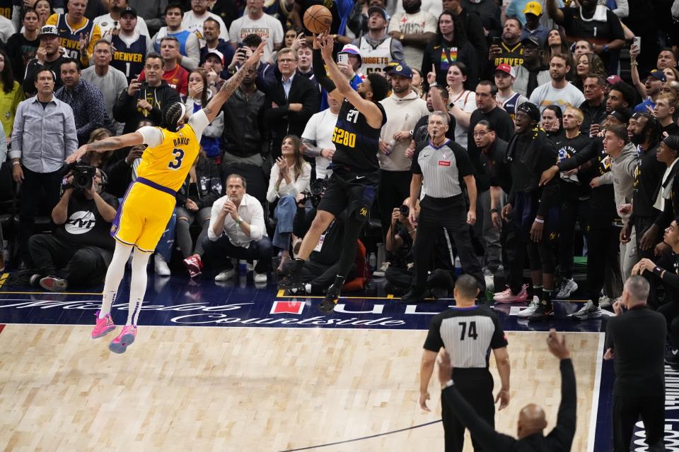 Denver Nuggets guard Jamal Murray (27) hits the game-winning basket against Los Angeles Lakers forward Anthony Davis (3) during the second half in Game 2 of an NBA basketball first-round playoff series Monday, April 22, 2024, in Denver. (AP Photo/Jack Dempsey)