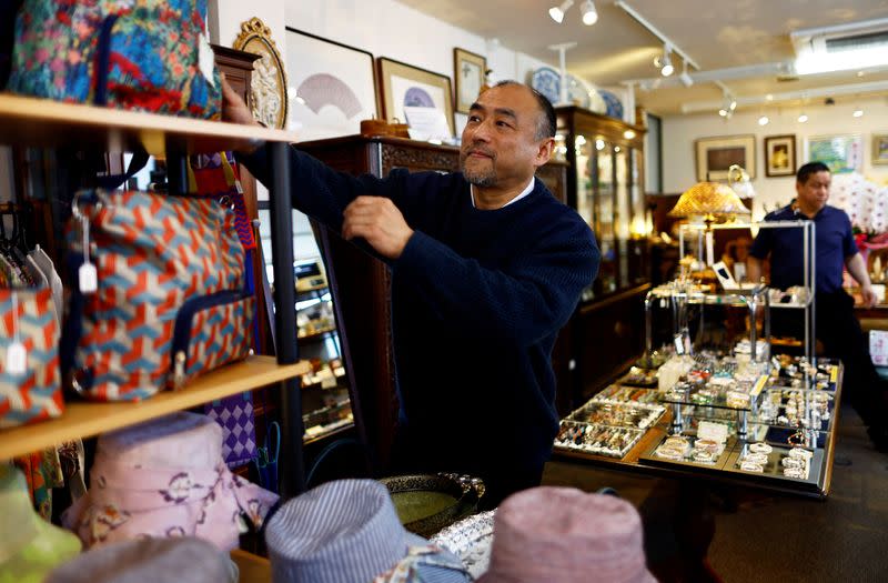 Yasunobu Tashiro works at his gift shop at Kinugawa Onsen, a hot-spring resort, in Nikko, Japan