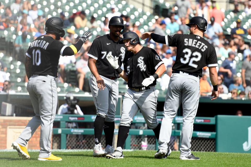 White Sox's Andrew Vaughn, third from right, is congratulated after hitting a grand slam scoring from left, Yoan Moncada, Eloy Jimenez, and Gavin Sheets in the fifth inning Sunday, Sept. 18, 2022, in Detroit.