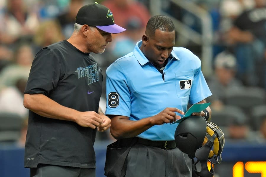 Tampa Bay Rays manager Kevin Cash, left, talks to home plate umpire Ramon De Jesus during the fourth inning of a baseball game against the New York Yankees Saturday, May 11, 2024, in St. Petersburg, Fla. (AP Photo/Chris O’Meara)