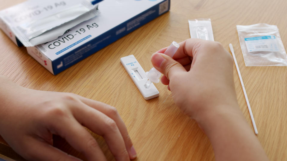 Close-up face of young adult asia woman people use auto PCR cotton self cure kit from hospital clinic service by telehealth telemedicine call support in cold flu virus health care isolate at home.