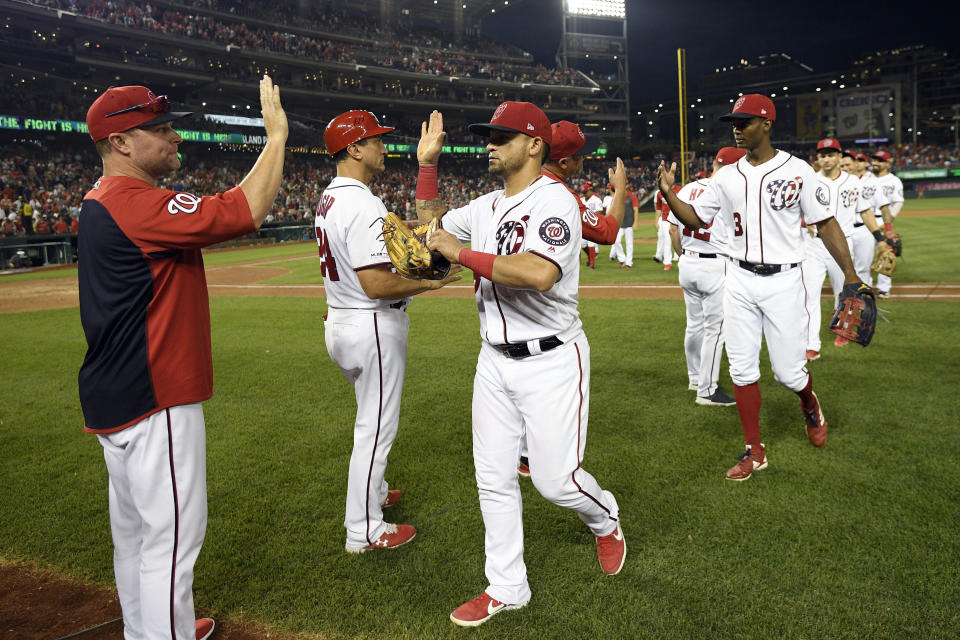 Washington Nationals' Gerardo Parra, third from left, and others celebrate after a baseball game against the Cleveland Indians, Saturday, Sept. 28, 2019, in Washington. (AP Photo/Nick Wass)