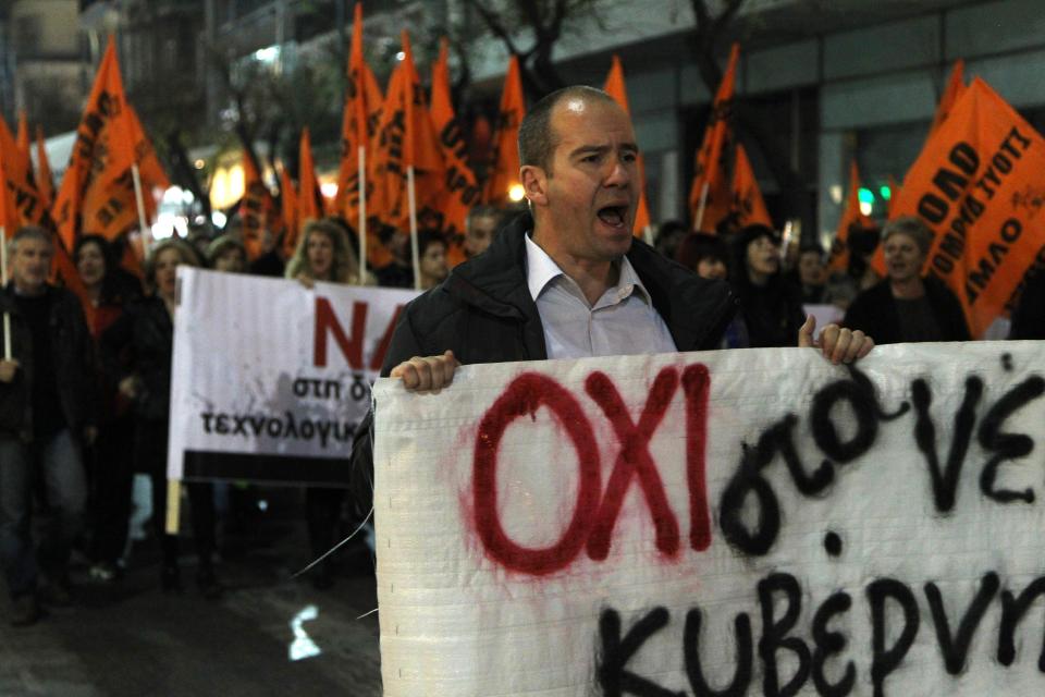 A protester chants anti-austerity slogans as he holds a banner which reads in Greek "No to the new murderous measures of government" during a rally in the northern Greek port city of Thessaloniki, Greece, Tuesday, April 1, 2014. Hundreds of demonstrators protested against the Eurogroup and the meeting of all European Union finance ministers in Athens. (AP Photo / Nikolas Giakoumidis)