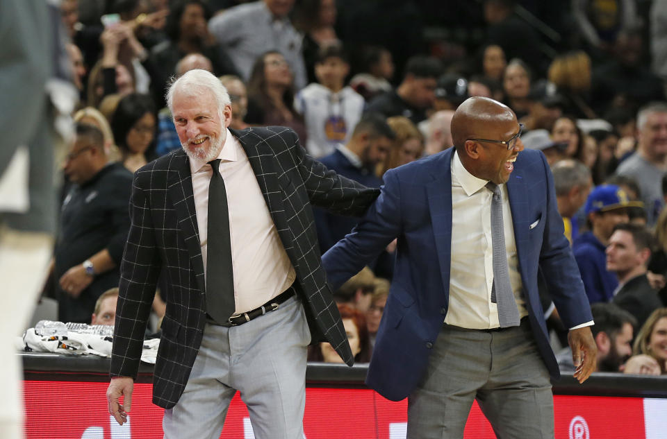 SAN ANTONIO, TX - DECEMBER 31: Head coach of the San Antonio Spurs Gregg Popovich greets assistant coach of the Golden State Warriors Mike Brown at the end of regulation but the game was not over at AT&T Center on December 31, 2019 in San Antonio, Texas.  NOTE TO USER: User expressly acknowledges and agrees that , by downloading and or using this photograph, User is consenting to the terms and conditions of the Getty Images License Agreement. (Photo by Ronald Cortes/Getty Images)