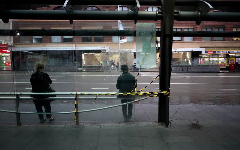 People follow a social distancing at a bus stop, as New South Wales begins shutting down non-essential businesses and moving toward harsh penalties to enforce self-isolation to avoid the spread of coronavirus disease (COVID-19), in Sydney