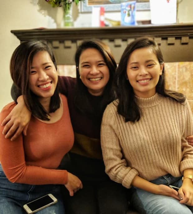 Anne Ignacio (centre) and her two sisters. Anne said she started studying kinesiology after being unable to pass the IELTS, one of the requirements for working as a registered nurse in B.C. (Anne Ignacio/Submitted - image credit)