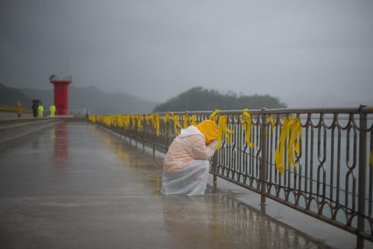 A relative weeps near Jindo harbour where family members of the 'Sewol' ferry disaster victims are waiting for news on the search and recovery operations, on April 27, 2014