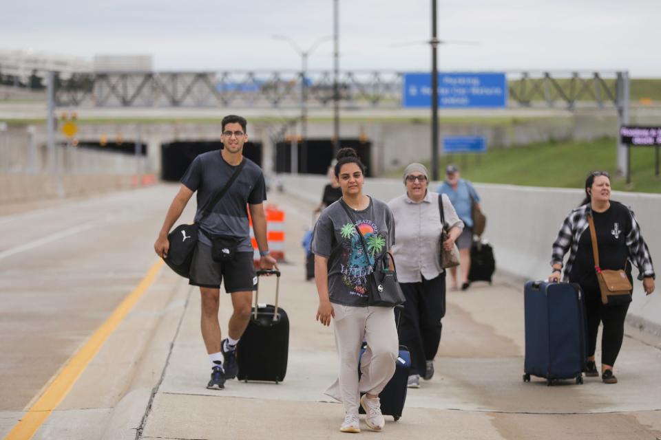 Flooding around the Detroit Metropolitan Airport left passengers and would-be travelers stranded after a deluge of rain overnight on Thursday, Aug. 24, 2023. Many passengers walked to Eureka Road from McNamara Terminal after landing in hopes of finding their family.