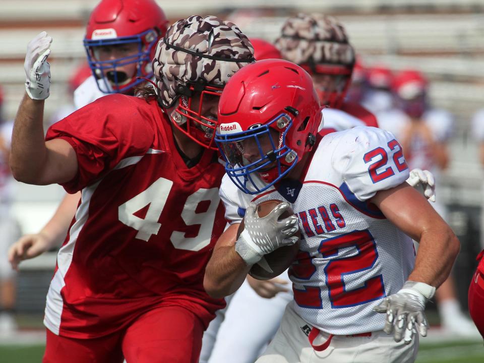 Licking Valley's Trenton Markus attempts to turn the corner while being pursued by Utica's Brandon Thornsberry during a scrimmage on Saturday, August 5, 2023.