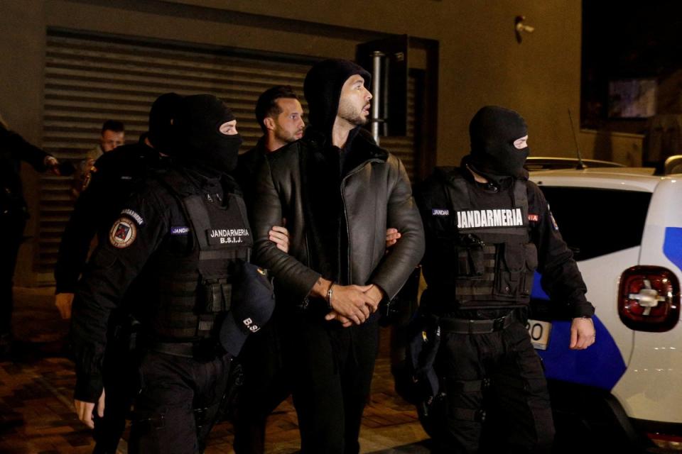 Andrew Tate and Tristan Tate are escorted by police officers outside the headquarters of the Directorate for Investigating Organized Crime and Terrorism in Bucharest ( (REUTERS)