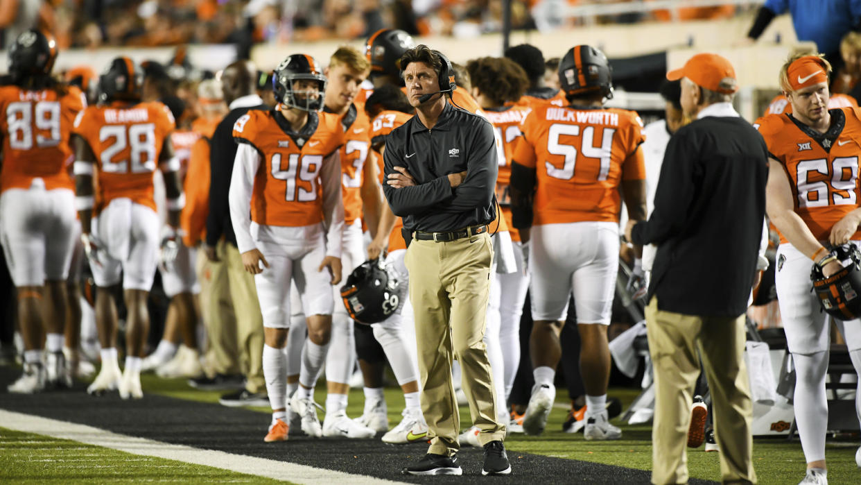 Oklahoma State head coach Mike Gundy looks to the scoreboard during a timeout. during an NCAA college football game against Kansas, Saturday, Oct. 30, 2021, in Stillwater, Okla. (AP Photo/Brody Schmidt)